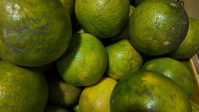 Gathering of fresh green limes in a basket showcasing their vibrant colors and textures