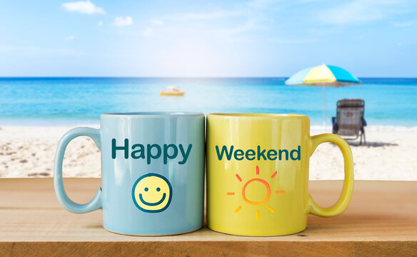 Happy weekend on coffee mug over blurred tropical beach background, summer season, outdoor day light