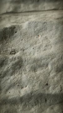 Vertical close up of decorative grey stone wall texture, architectural detail, camera tilt down, natural rock surface, construction material, exterior home design, candid style, masonry work.