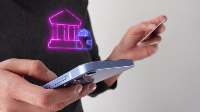 Managing personal finances at the bank. Businesswoman holding a bank card while holding a smartphone with a virtual bank icon and wallet.
