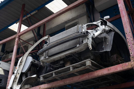 Auto parts warehouse. Wrecked car, Scrap car, Junk car on shelf at garage. Automotive spare parts warehouse