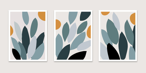 Set of three minimalist abstract botanical wall art prints featuring stylized foliage and leaves in muted teal, dark green, and black with mustard yellow circles on a beige background. © indra