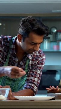 Making chapati together, Indian father and daughter bonding in modern kitchen, Asian dad teaching young girl cooking, family quality time at home, child helping parent with food preparation