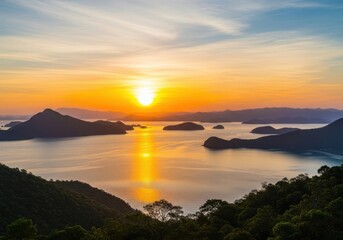 Fototapeta premium Dramatic sunrise over misty tropical islands with golden reflection
