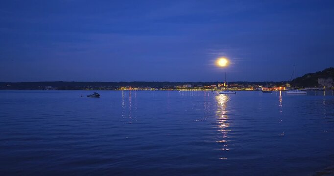 Fantastic full moon in Arona on lake Maggiore in Italy.
