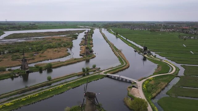 Aerial view rising over the historic Kinderdijk windmills, in cloudy Netherlands