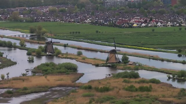 Aerial telephoto shot around traditional Dutch windmills in the canals of Kinderdijk