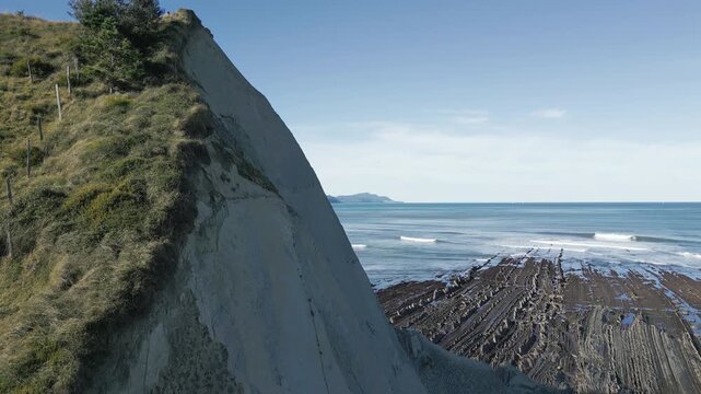 Stunning aerial view of the Sakoneta beach revealing the unique flysch rock formations, a geological wonder along the rugged coastline of the Basque Country in northern Spain