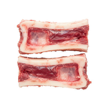 Two raw veal marrow bones side-by-side on a transparent background, showcasing porous ivory surfaces and glistening red marrow, emphasizing rustic culinary elegance