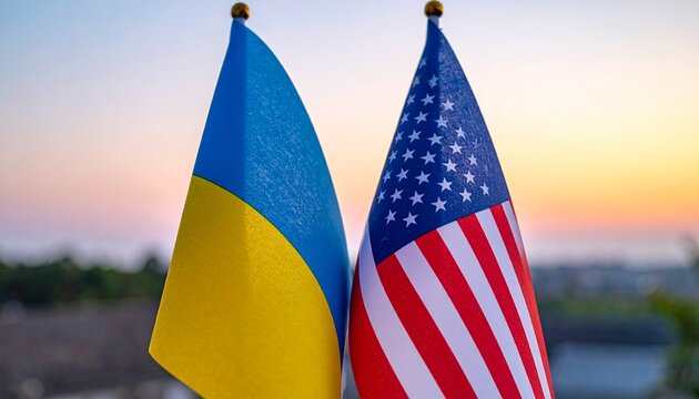 United States and Ukraine flags side by side at sunset, symbolizing solidarity, partnership, resilience, and unity, with warm light enhancing peaceful and diplomatic composition.