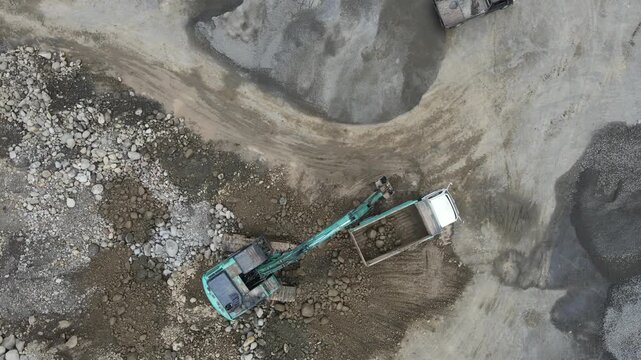 Aerial View of Mining Work in Rock and Ore Quarry, Open Pit Industrial Extraction Site view from above, representing large-scale energy and infrastructure development
