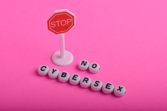 Words no cybersex formed with letter beads and a red stop sign, representing online safety awareness, digital protection, and prevention of inappropriate internet behavior.