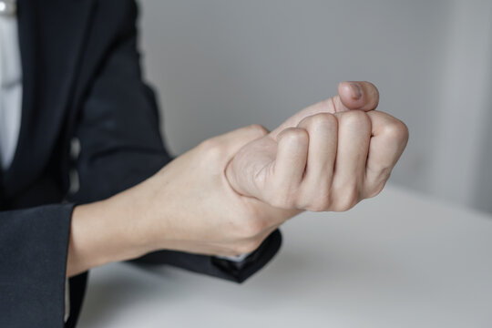 Woman hand with wrist pain numbness and pain in the palm of the hand has pain and tingling in the nerve endings This is a side effect of sitting and working for a long time on a laptop at the office