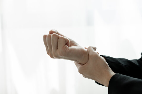 Woman hand with wrist pain numbness and pain in the palm of the hand has pain and tingling in the nerve endings This is a side effect of sitting and working for a long time on a laptop at the office