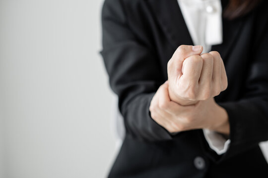 Woman hand with wrist pain numbness and pain in the palm of the hand has pain and tingling in the nerve endings This is a side effect of sitting and working for a long time on a laptop at the office