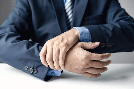man hand with wrist pain numbness and pain in the palm of the hand has pain and tingling in the nerve endings This is a side effect of sitting and working for a long time on a laptop at the office