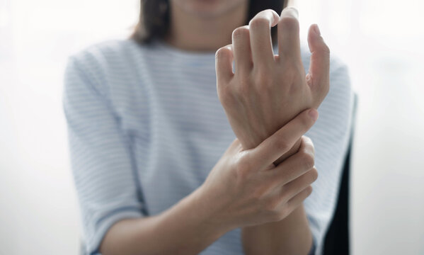 Woman hand with wrist pain numbness and pain in the palm of the hand has pain and tingling in the nerve endings This is a side effect of sitting and working for a long time on a laptop at the office