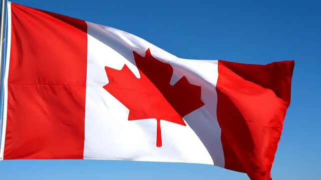 Canadian flag waving in blue sky
