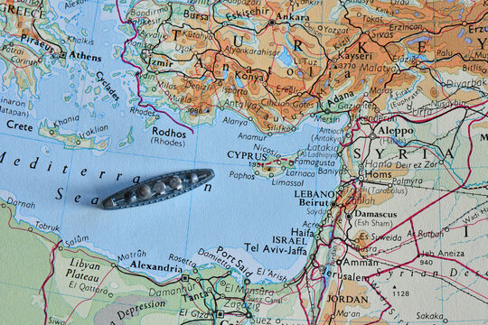 Toy battleship on a vintage map of the Eastern Mediterranean Sea, near Cyprus, Turkey, and Lebanon, representing maritime travel, logistics, exploration, and naval strategy.
