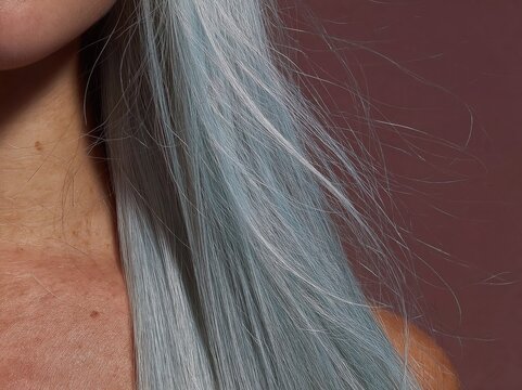 Long straight silver blue hair flowing vertically against a mauve background for hair salon advertising, professional hair care marketing and beauty product packaging