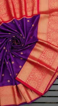 Deep purple silk saree with intricate gold zari border and motifs during studio lighting
