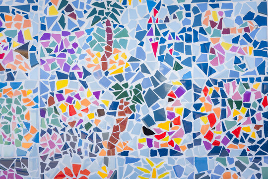 Colorful abstract ceramic mosaic. Close up. Mosaic on the wall with fragments of blue, white, black colors with pieces.