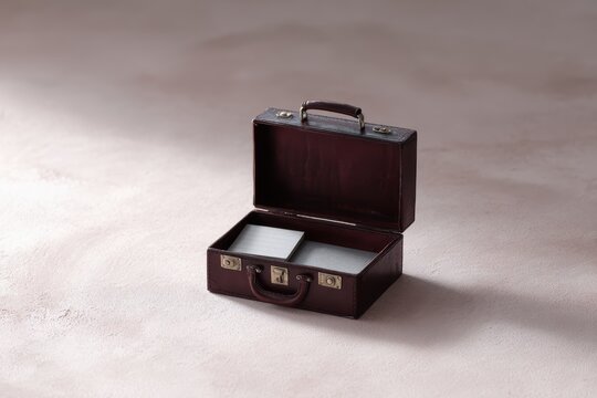 open leather briefcase revealing miniature remote office interior creative concept