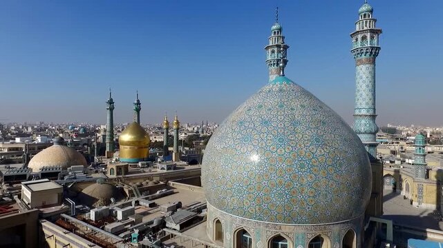  Aerial view of a large blue mosaic dome with twin minarets overlooking a dense city, showcasing Islamic shrine architecture, religious heritage, urban scale, and spiritual atmosphere. 