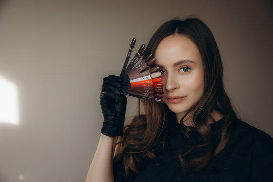 Manicurist holding diverse nail polish color palette