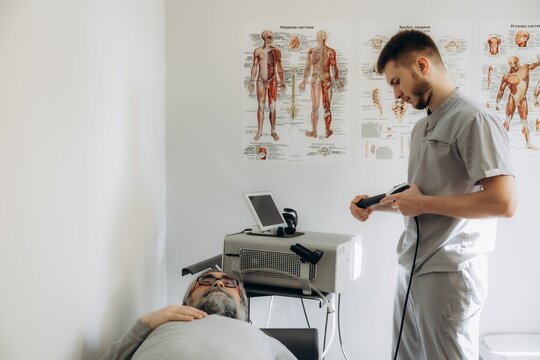 Doctor preparing medical equipment for physical therapy session