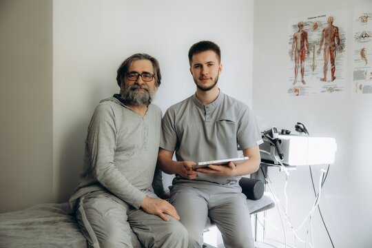 Physiotherapist and senior patient during therapy consultation
