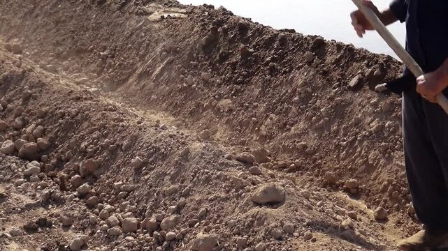  Close up of dry rocky soil and eroded earth layers in desert terrain showing natural geological textures, climate effects, and rough surface patterns under sunlight. 