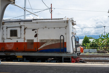 Close view of locomotive side at railway platform showing mechanical details and industrial transportation environment © InveStock