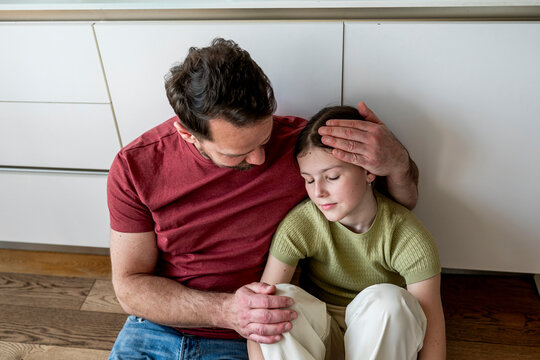 Parent providing mental health support to teenage child facing challenges at home.