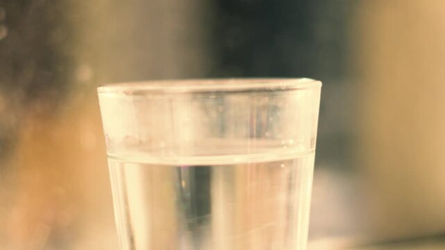 Static Shot of Clear Glass of Water in Warm Natural Light. H20. Refreshing Drink.