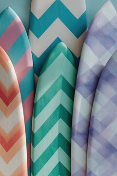Surfboard tips leaning together against patterned wall close up