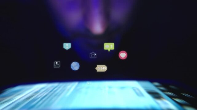 Glowing social media icons floating over a phone in a dimly lit room with colorful lighting and digital distraction