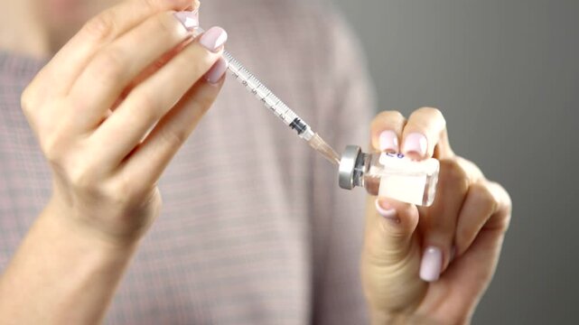 Nurse Hands Drawing Liquid Medicine From Glass Vial Into Syringe.   Preparing Vaccine Or Insulin Injection