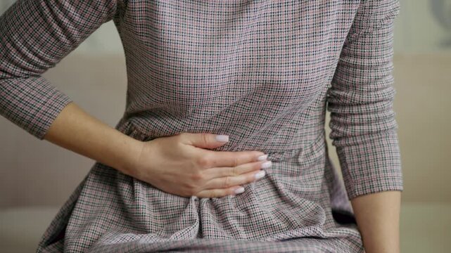 Patient Feeling Discomfort From Cramps And Bloating. Menstrual Pain Relief