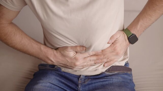 Patient Suffering From Severe Stomach Ache. Medical Health Issue Of Digestive System Problems. Intestinal Infection