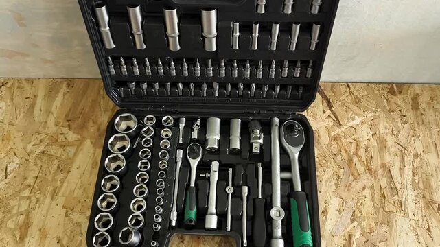 A large open case with ratchets, screwdriver attachments, hand tools. Car repair shop, garage