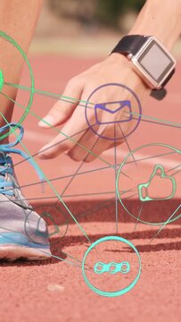 Vertical video: Watch entering, runner tying lace preparing for sports while heart aligning wrist