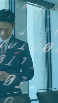 Vertical video: Male exec tapping phone in glass room, viewing IT data with binary overlay drifting