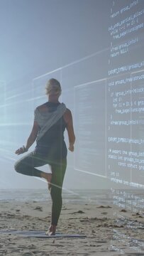 Vertical video: Woman holding tree pose on beach sun starting code overlay shifting arms for health