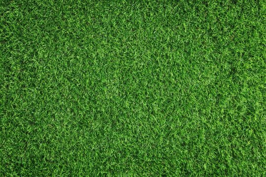 High resolution top down view of lush green artificial grass surface texture perfect for sports fields or landscaping design projects. High quality photo