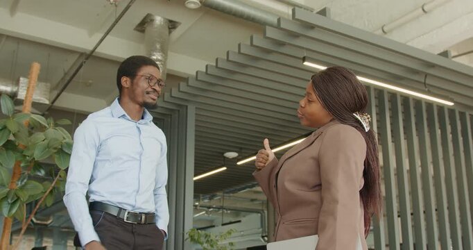 Black professionals exchanging upbeat agreement gestures