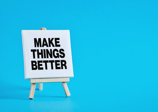 Small easel displaying make things better motivational message on blue background