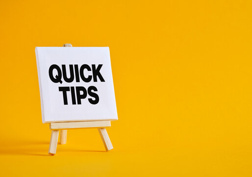 White Canvas Showing Quick Tips announcement on Wooden Easel with Yellow Background