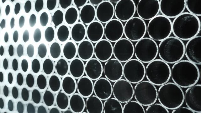 Collection Of Circular Steel Channels Displayed In Structured Rack Pattern With Contrasting Tones