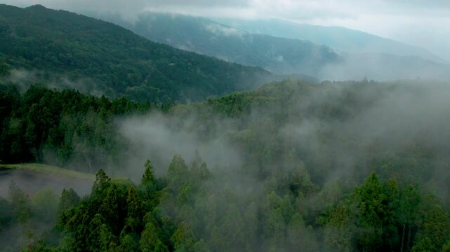 Aerial view misty foggy mountain landscape with clouds
